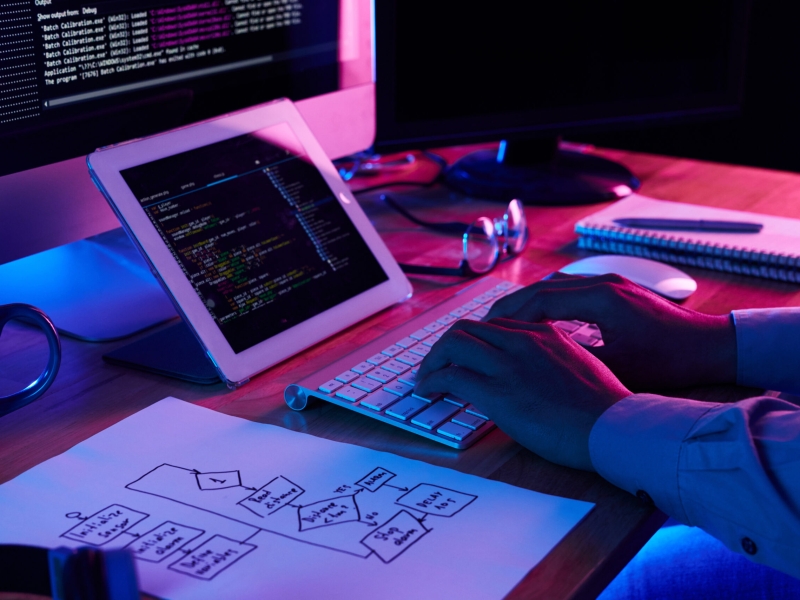 Close-up image of programmer working at his desk in office